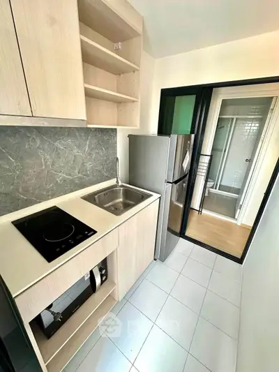 Modern compact kitchen with sleek appliances and stylish cabinetry