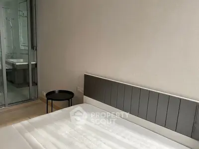 Modern minimalist bedroom with ensuite bathroom and sleek furnishings