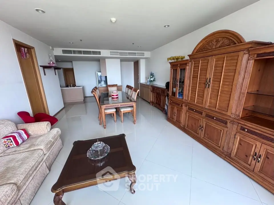 Spacious living room with elegant wooden furniture and modern decor in a bright apartment.