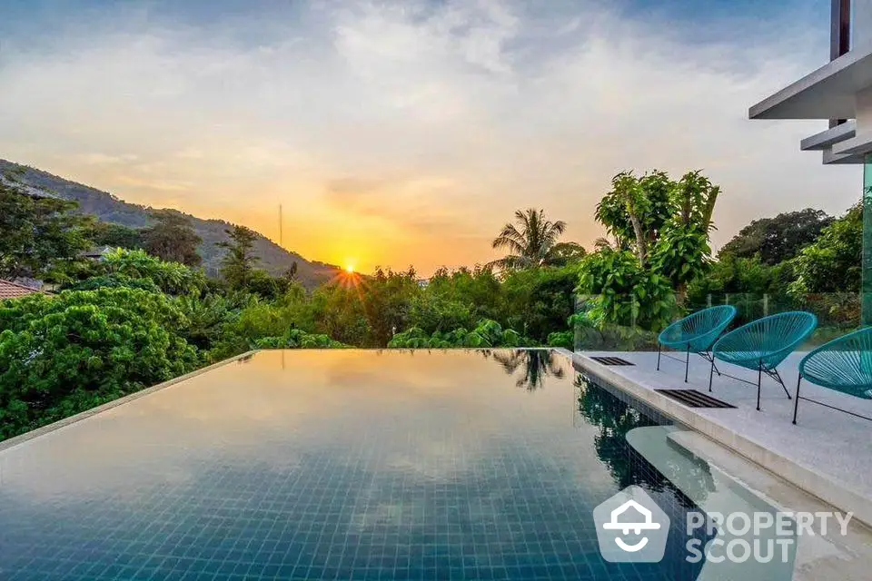 Stunning infinity pool with breathtaking sunset view and lush greenery