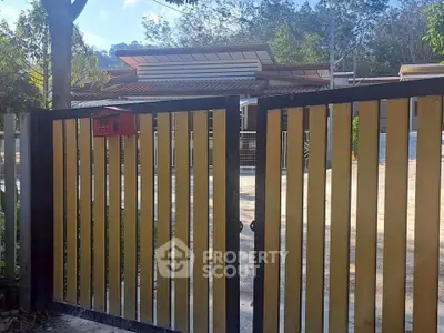 Charming modern home with stylish gate and lush surroundings