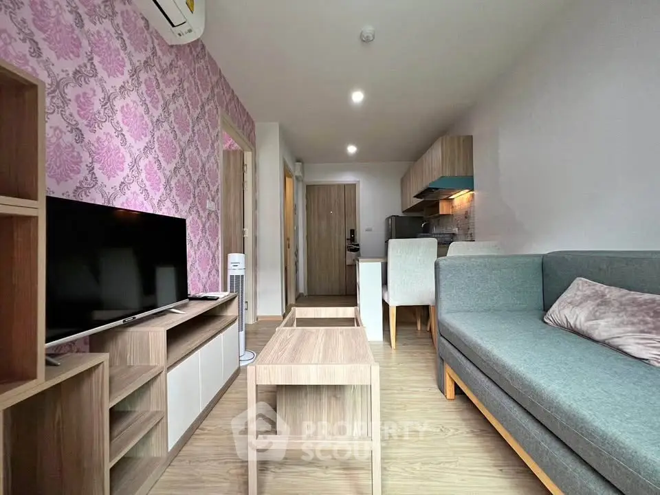 Modern living room with stylish furniture and open kitchen layout in a cozy apartment.