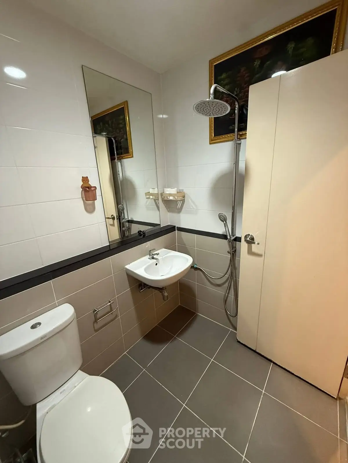 Modern bathroom with shower, toilet, and sink in a compact layout.