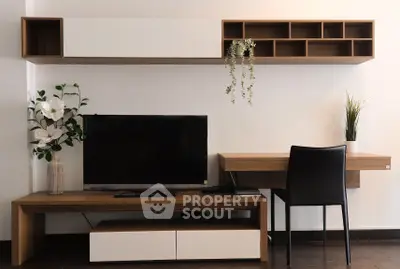 Modern living room with sleek TV stand, wall shelves, and stylish decor