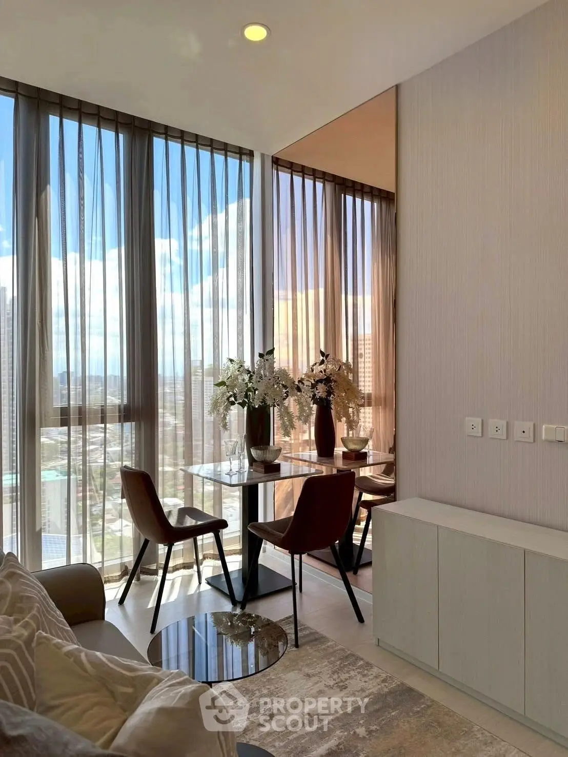 Modern living room with floor-to-ceiling windows and stunning city view