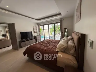 Luxurious bedroom with pool view and modern decor in a stylish home