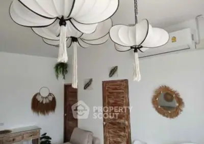 Chic living room with unique pendant lights and rustic decor elements.