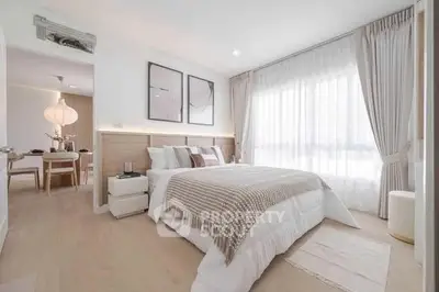Bright and spacious bedroom with modern decor and large window for natural light.