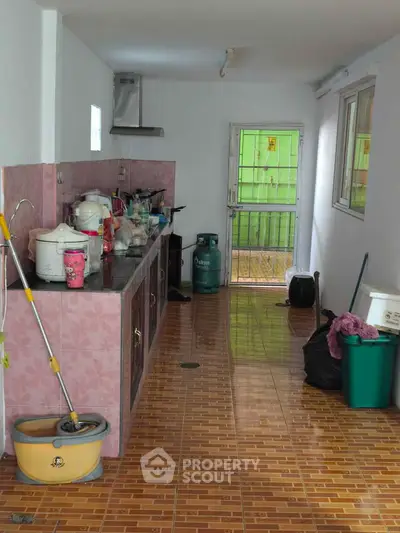 Spacious kitchen with tiled floor and ample counter space, featuring a gas stove and modern appliances.