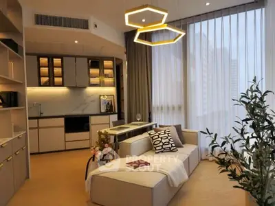 Modern living room with open kitchen and stylish lighting