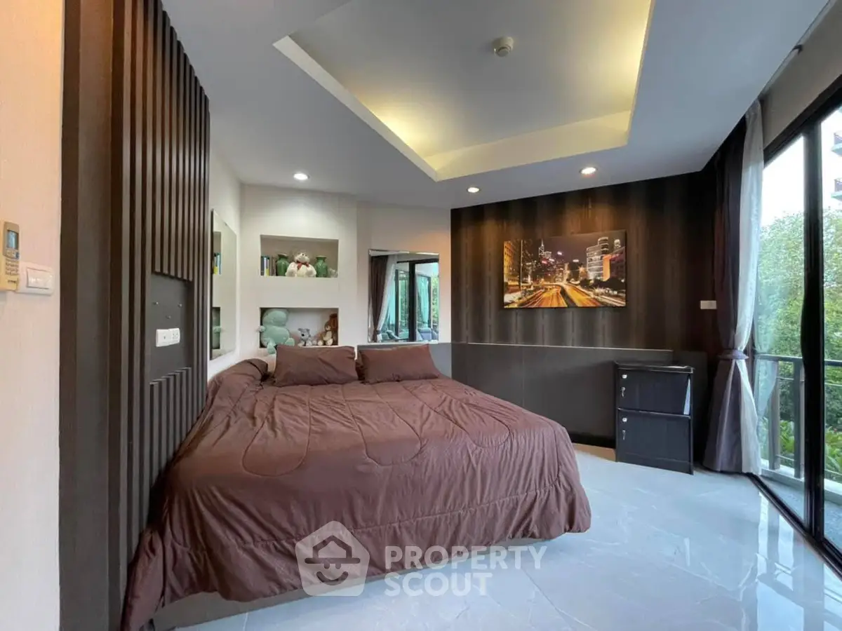 Luxurious bedroom with modern decor and large windows offering a stunning view, perfect for relaxation.