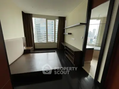 Modern bedroom with city view and sleek dark flooring