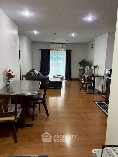 Spacious living room with modern dining area and cozy seating, perfect for family gatherings.
