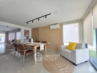 Spacious modern living room with elegant dining area and natural light