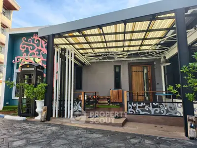 Modern house entrance with stylish patio and unique architectural design.