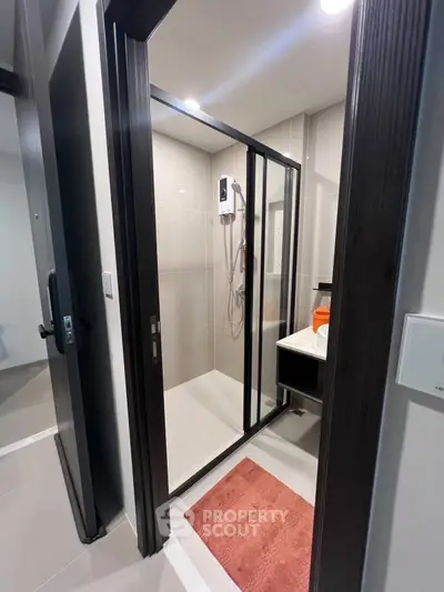 Modern bathroom with glass shower enclosure and sleek design