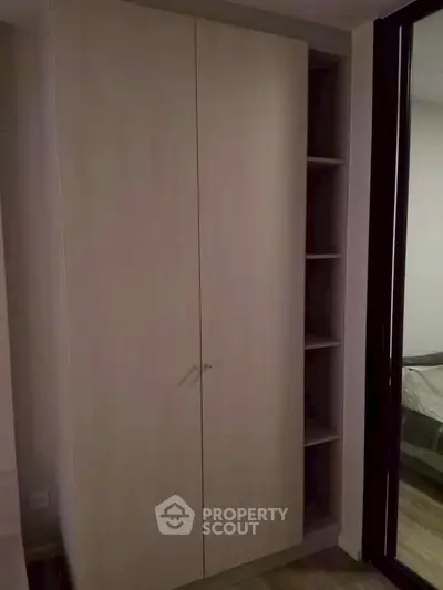 Spacious wardrobe in modern bedroom with sleek design and ample storage space.