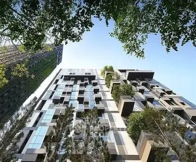 Modern architectural building with lush greenery and unique facade design.