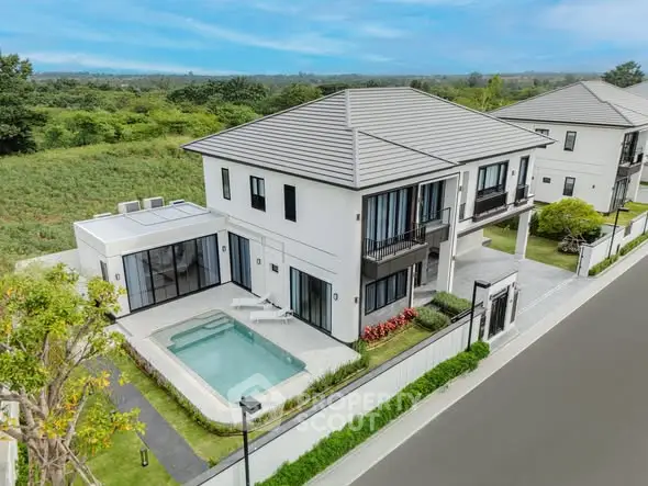 Luxurious modern house with private pool and lush surroundings, perfect for serene living.