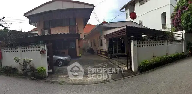 Charming suburban home with spacious driveway and lush greenery, perfect for family living.