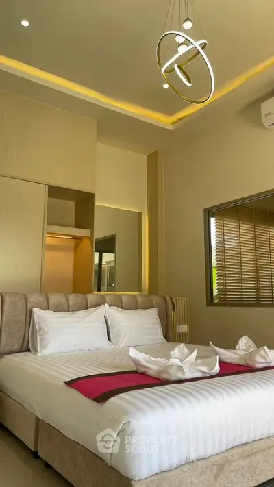 Luxurious bedroom with modern decor and elegant lighting, featuring a plush bed and stylish accents.