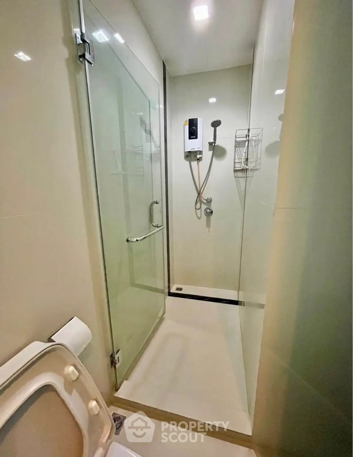 Modern bathroom with glass shower enclosure and sleek fixtures