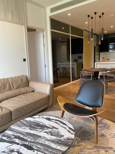 Modern open-layout living room with stylish furniture and elegant lighting, perfect for contemporary living.