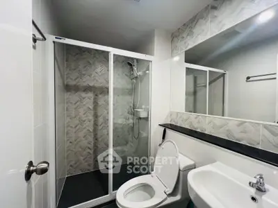 Modern bathroom with sleek shower enclosure and stylish tile design.
