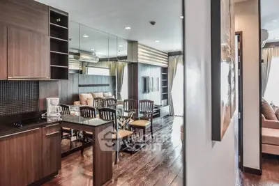 Modern open-layout living room with elegant dining area and sleek kitchen design.