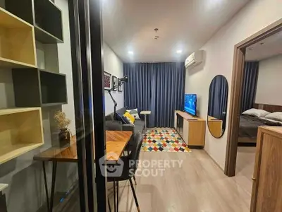 Modern living room with stylish decor and open view into bedroom