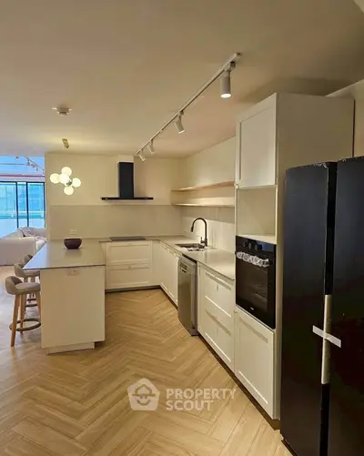 Modern kitchen with sleek appliances and open layout in a stylish apartment.