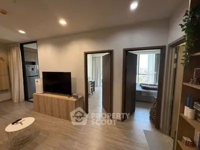 Modern apartment interior with open living area and bedroom view