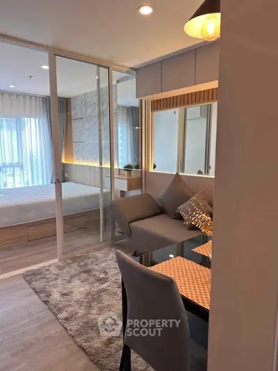 Modern living room with cozy seating and stylish decor in a bright apartment.