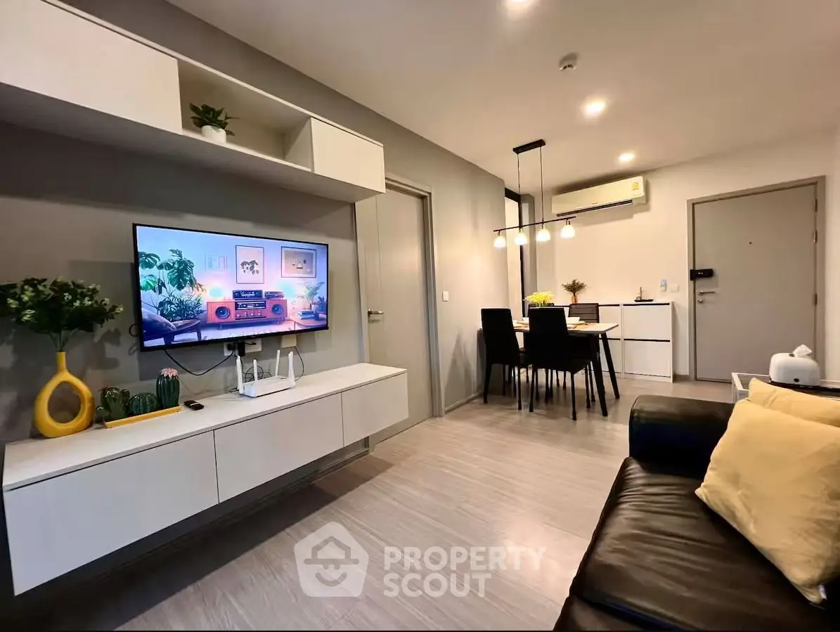 Modern living room with sleek furniture and dining area, perfect for urban living.