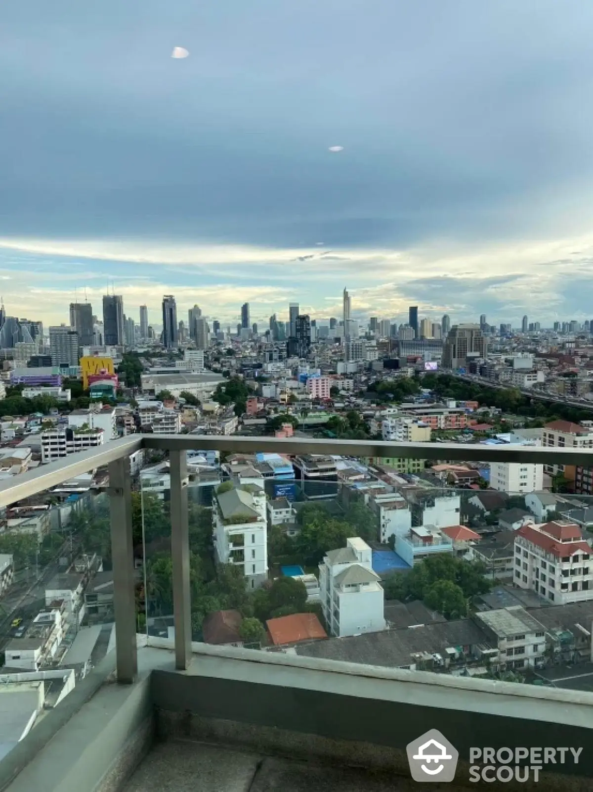 Stunning cityscape view from high-rise balcony in urban setting