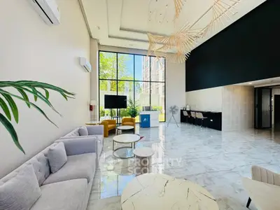 Luxurious modern lobby with high ceilings and elegant decor in a contemporary building.