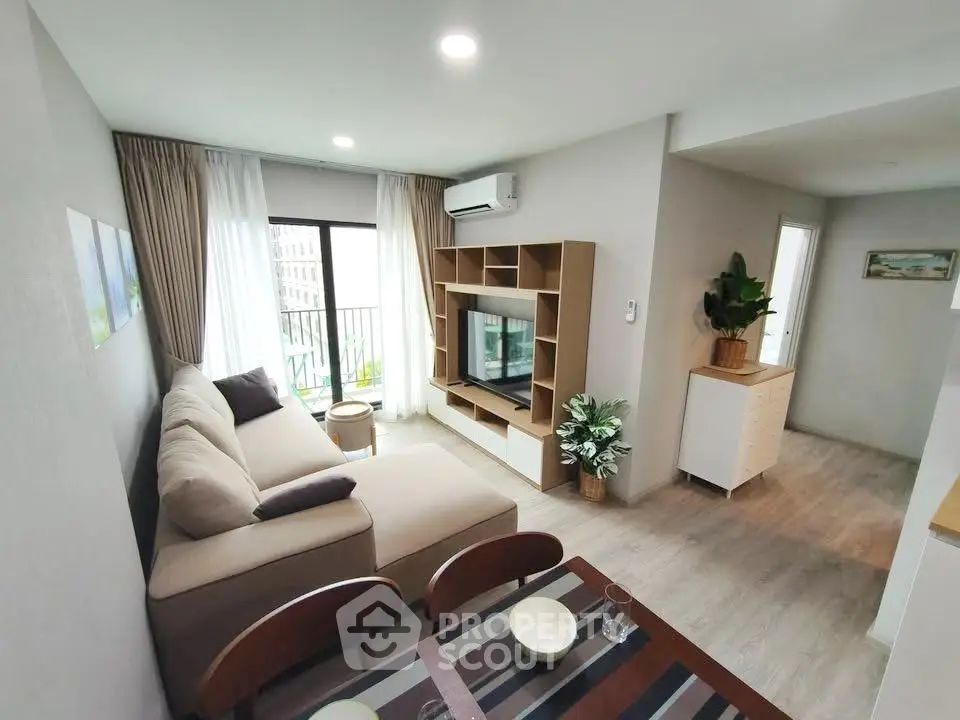 Modern living room with cozy sofa and stylish entertainment center in a bright apartment.