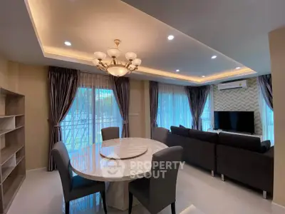 Modern living room with elegant chandelier and large windows