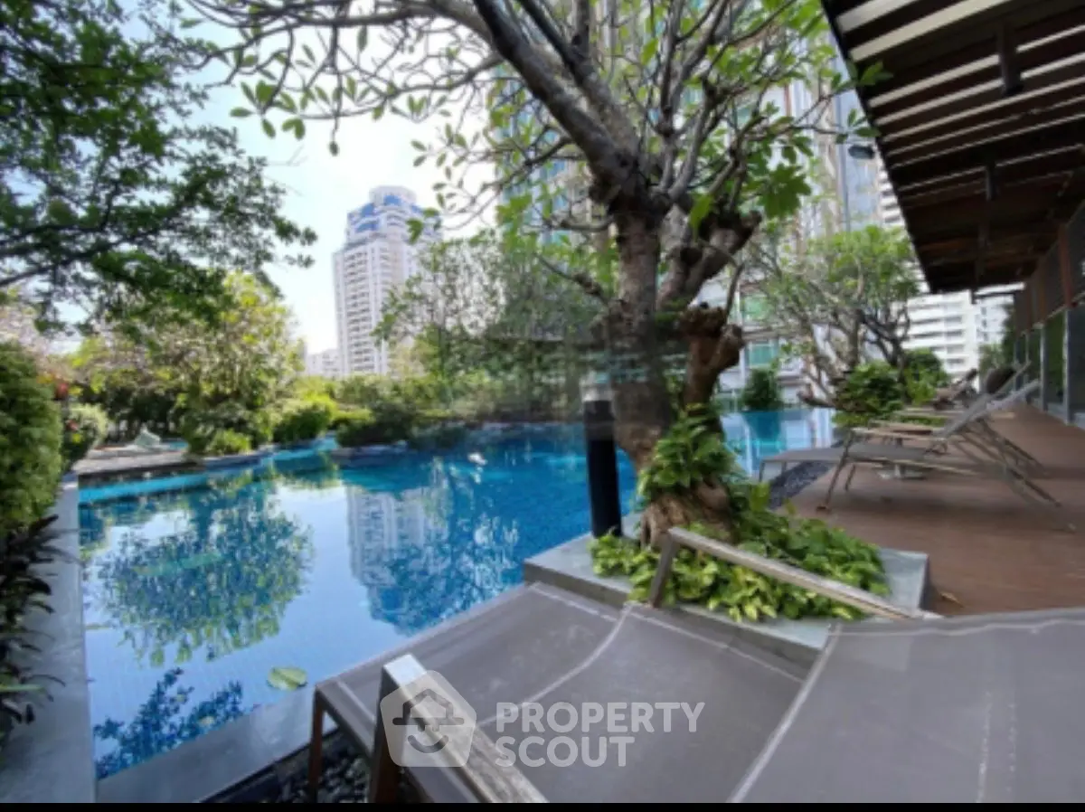 Luxurious urban poolside oasis with lush greenery and city views.