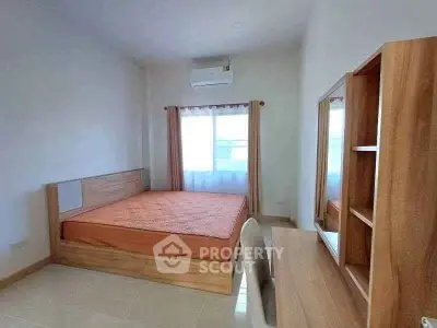 Spacious bedroom with modern wooden furniture and natural light