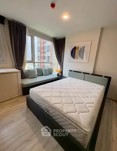 Modern bedroom with large window and stylish decor in urban apartment