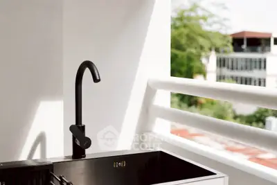 Modern balcony with sleek black faucet and scenic view, perfect for urban living.