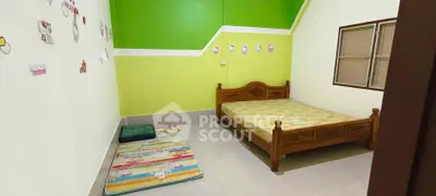 Cozy bedroom with vibrant green walls and wooden bed frame, perfect for a comfortable living space.