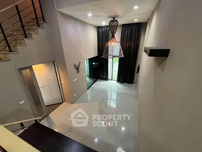 Spacious modern living room with high ceiling and elegant lighting