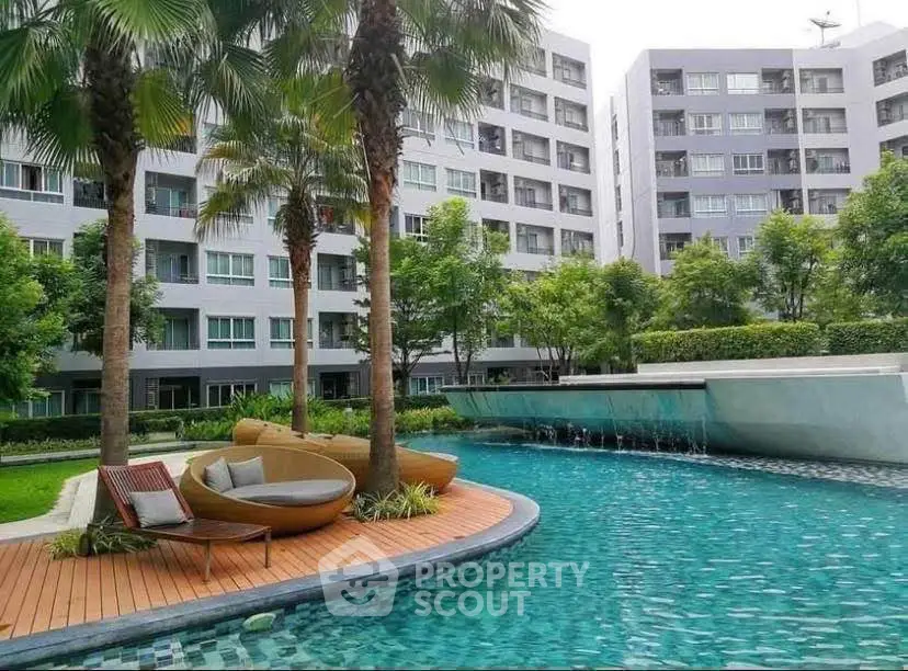 Luxurious apartment complex with stunning pool and lush greenery, perfect for relaxation and modern living.