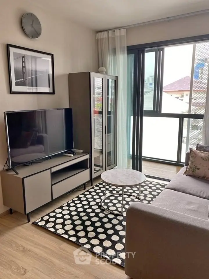 Modern living room with stylish decor and large window for natural light.