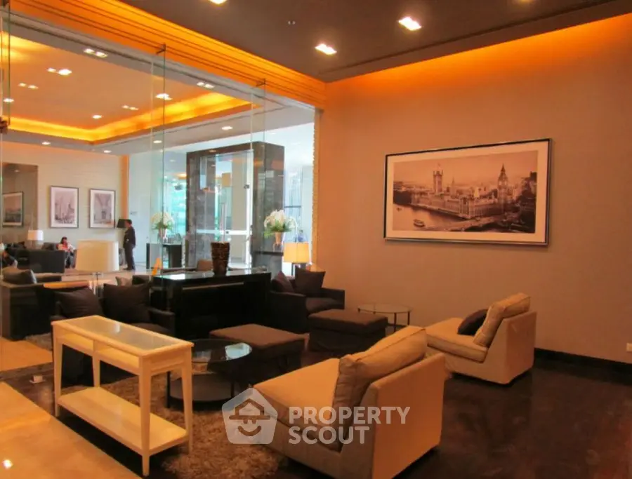 Luxurious modern living room with elegant seating and ambient lighting in upscale property.