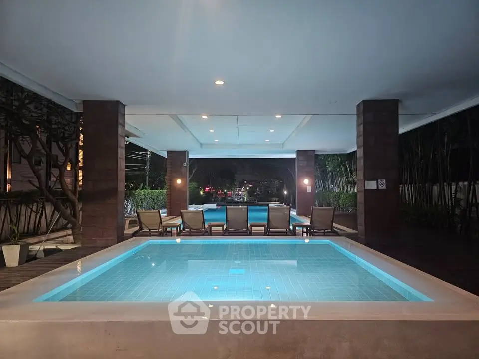 Luxurious indoor pool area with ambient lighting and comfortable lounge chairs.