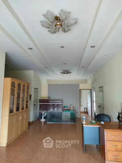 Spacious living room with wooden flooring and elegant ceiling lights