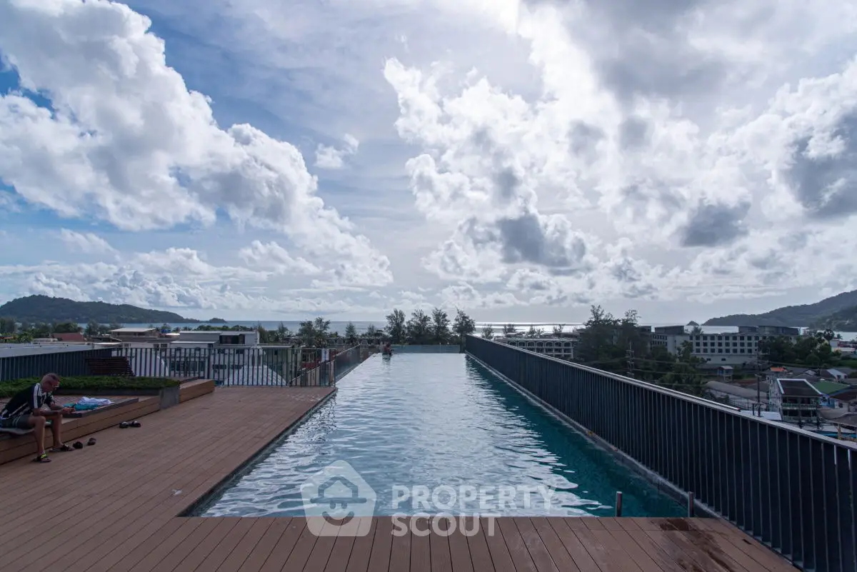 Stunning rooftop infinity pool with breathtaking ocean view and expansive sky.